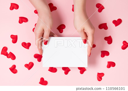 Female hands hold a greeting card for valentine's day. Place for your text. Female hands hold a greeting card for valentine's day. Place for your text. 110566101