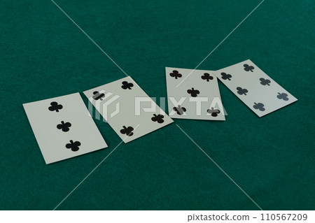 Old west era playing card on gambling table. 3,4,5,6 of clubs. 110567209