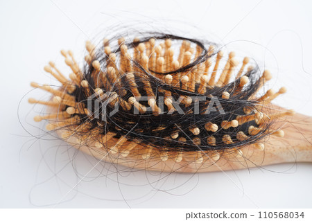Hair loss fall with comb brush isolated on white background. Hair loss fall with comb brush isolated on white background. 110568034