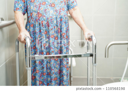 Asian elderly old woman patient use toilet support rail in bathroom, handrail safety grab bar, security in nursing hospital. Asian elderly old woman patient use toilet support rail in bathroom, handrail safety grab bar, security in nursing hospital. 110568198