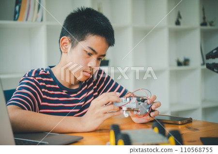 Asian boy learning and studying the work of technology robots.homeschool and science for tech project. playing childhood kids hobby leisure lifestyle people toys robotics technology. Asian boy learning and studying the work of technology robots.homeschool and science for tech project. playing childhood kids hobby leisure lifestyle people toys robotics technology. 110568755