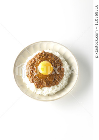 An overhead shot of keema curry topped with egg yolk against a white background An overhead shot of keema curry topped with egg yolk against a white background 110569316