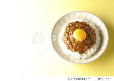 An overhead shot of keema curry topped with egg yolk An overhead shot of keema curry topped with egg yolk 110569360