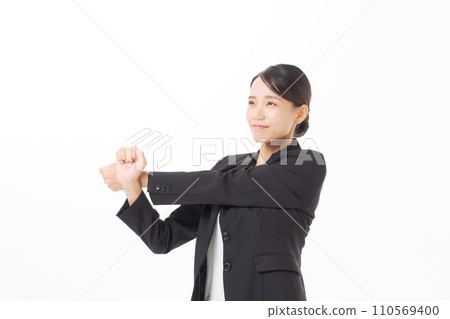 A woman in a suit stretching A woman in a suit stretching 110569400