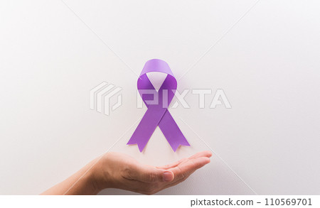 Hand holding purple ribbon on white background for supporting World Cancer Day campaign on February 4. 110569701