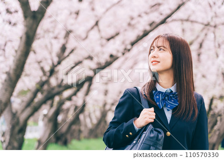 High school girl looking up at cherry blossoms High school girl looking up at cherry blossoms 110570330