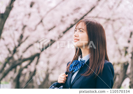 High school girl looking up at cherry blossoms High school girl looking up at cherry blossoms 110570334