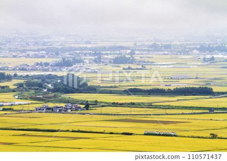 Landscape of the Aizu Basin during harvest season and Tadami Line train, overlooking Futanuma, Aizumisato Town, Fukushima Prefecture 110571437