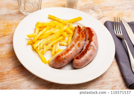 Fried meat sausages served with french fries at plate Fried meat sausages served with french fries at plate 110571537