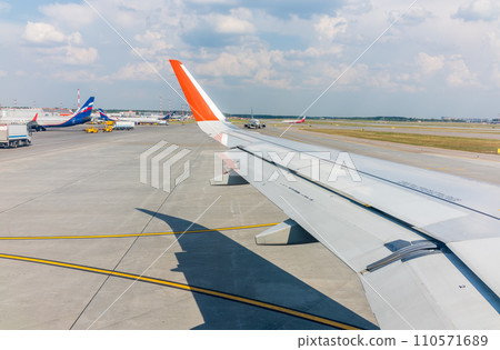 View from the airplane window during takeoff at Sheremetyevo airport at summer View from the airplane window during takeoff at Sheremetyevo airport at summer 110571689