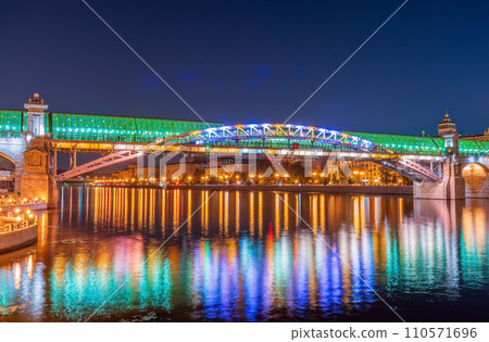 Pushkinskiy bridge with night illumination. Bridge to Gorky Park. Pushkinskiy bridge with night illumination. Bridge to Gorky Park. 110571696