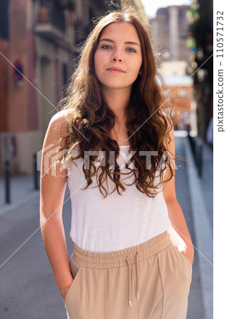 Cheerful attractive female walking on street outdoor 110571732