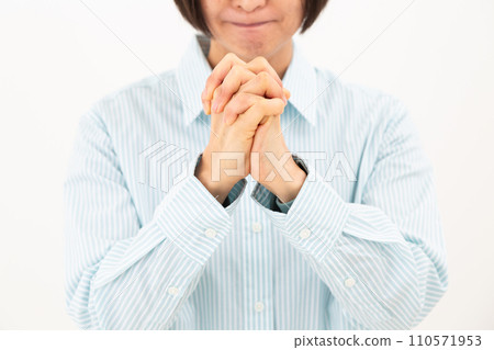 middle-aged woman putting her hands together 110571953