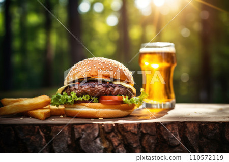 fresh burger on a wooden table with glass of cold fresh beer fresh burger on a wooden table with glass of cold fresh beer 110572119