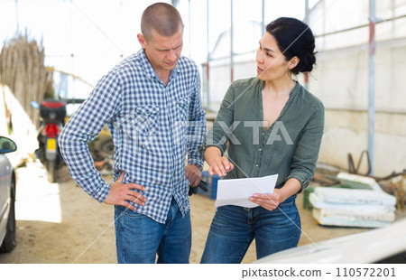 Two people with documents 110572201