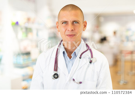 Portrait of positive friendly pharmacist or doctor in pharmacy Portrait of positive friendly pharmacist or doctor in pharmacy 110572384