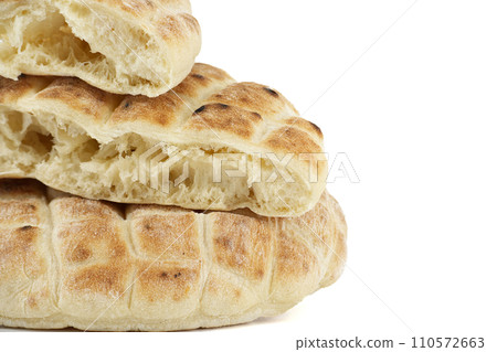 Toasted pita bread isolated on a white background Toasted pita bread isolated on a white background 110572663