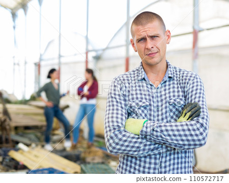Man in a greenhouse Man in a greenhouse 110572717