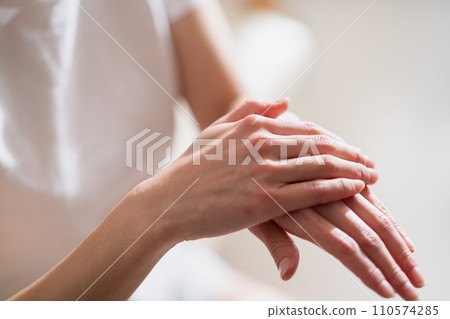 Women hand painting hand cream 110574285