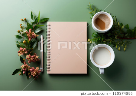Flat lay mockup notebook with springs, a pen, a cup of coffee and milk with flowers on a green background Flat lay mockup notebook with springs, a pen, a cup of coffee and milk with flowers on a green background 110574895
