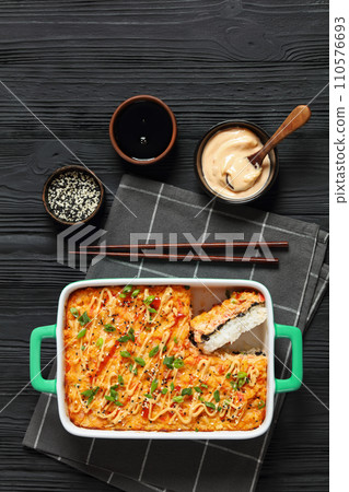 sushi bake with salmon, rice, seaweed, crab meat 110576693