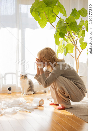 Owner worries as cat plays prank with toilet paper 110577280