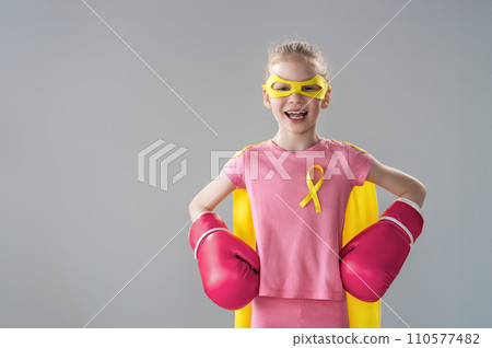 Child in boxing gloves with a yellow ribbon Child in boxing gloves with a yellow ribbon 110577482
