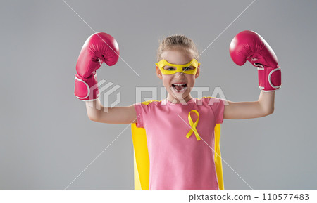 Child in boxing gloves with a yellow ribbon Child in boxing gloves with a yellow ribbon 110577483