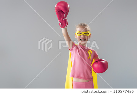 Child in boxing gloves with a yellow ribbon 110577486