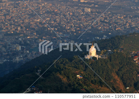 the outlook of Peace Pagoda in hill area with the townscape of Pokhara the outlook of Peace Pagoda in hill area with the townscape of Pokhara 110577951