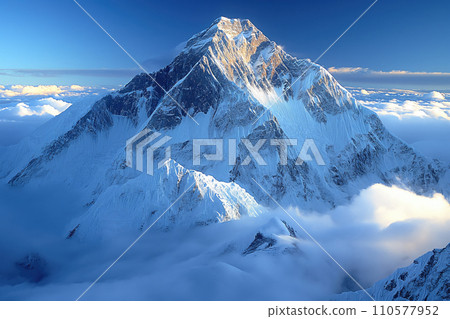 view of a high snowy mountain peak above the clouds 110577952