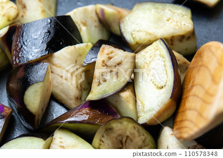 A cooking scene of frying eggplant in a frying pan. A cooking scene of frying eggplant in a frying pan. 110578348
