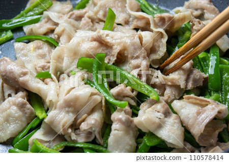 五花肉和青椒在煎鍋裡炒的烹飪場景。 110578414