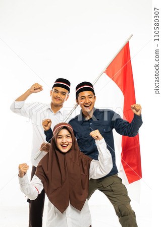 three islamic students standing clenched their arms and smiling three islamic students standing clenched their arms and smiling 110580307