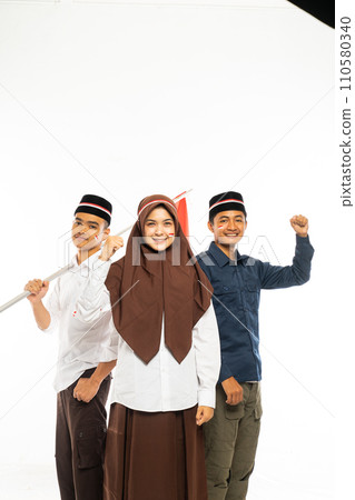 three islamic students standing together clenched their arm and smiling 110580340