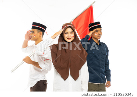 three islamic students standing with salutation and smiling bring the indonesian flag 110580343