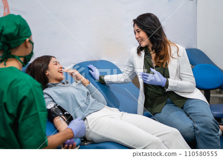 male doctor and female doctor accompanying female donors male doctor and female doctor accompanying female donors 110580555