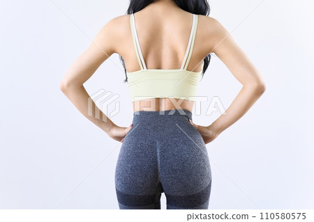 Rear view of a toned woman doing training Rear view of a toned woman doing training 110580575