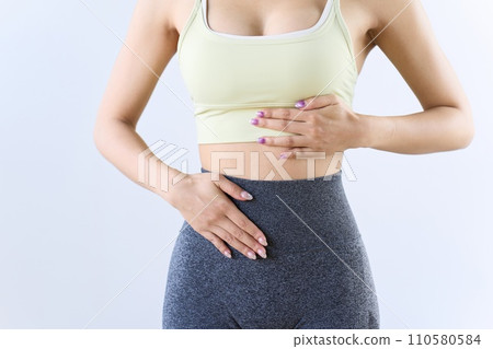 A woman suffering from stomach problems 110580584