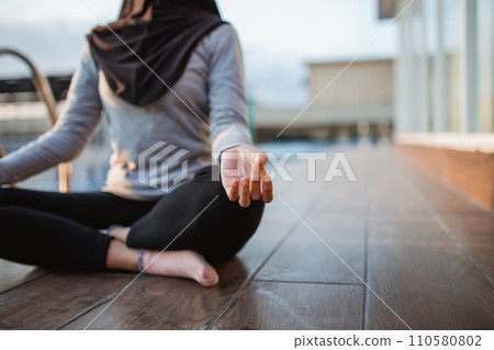 close up of a woman's hand pose meditating sitting by the pool close up of a woman's hand pose meditating sitting by the pool 110580802