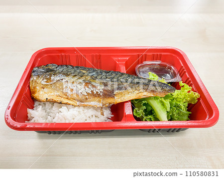 Saba fish grilled with salad in the food container on the table Saba fish grilled with salad in the food container on the table 110580831