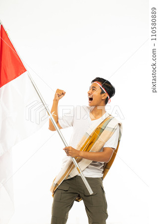 a handsome asian man with shoulder belt standing bring indonesia flag 110580889