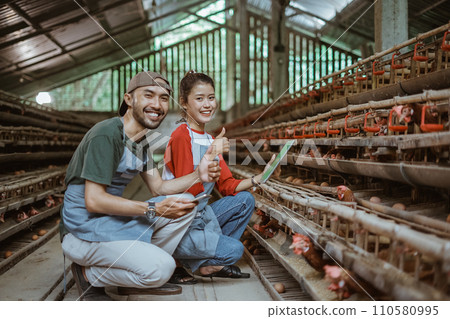 smiling Asian man and woman workers with thumbs up 110580995