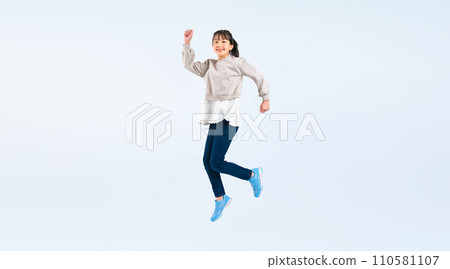 Full body photo of a girl jumping 110581107