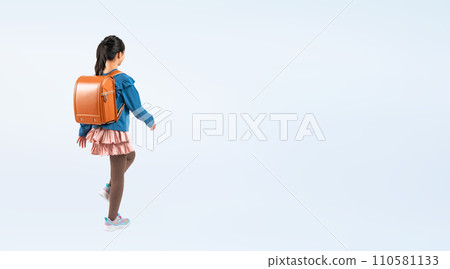 Female elementary school student walking with a school bag on her back Female elementary school student walking with a school bag on her back 110581133