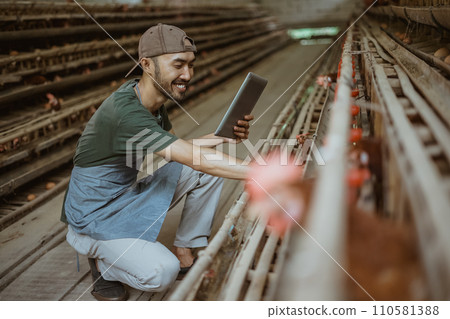 Young entrepreneur enjoy working with tablet while check eggs Young entrepreneur enjoy working with tablet while check eggs 110581388