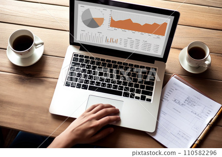 Generative AI of a man typing some economic graphs on the background of a wooden table 110582296