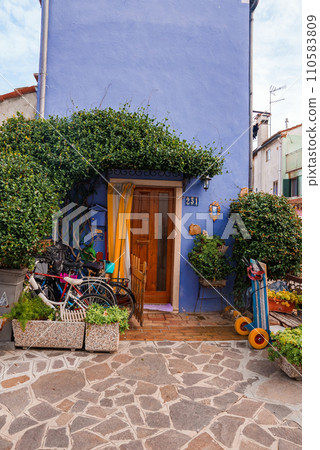 Charming blue house with a bike parked in front, capturing the unique charm of Venice. Quaint and picturesque scene, perfect for travel and architecture themes. Charming blue house with a bike parked in front, capturing the unique charm of Venice. Quaint and picturesque scene, perfect for travel and architecture themes. 110583809