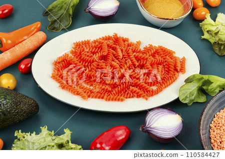 Uncooked fusilli pasta. 110584427