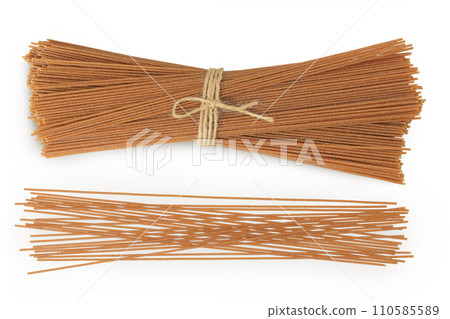 raw wholegrain spaghetti isolated on a white background. Top view. Flat lay 110585589